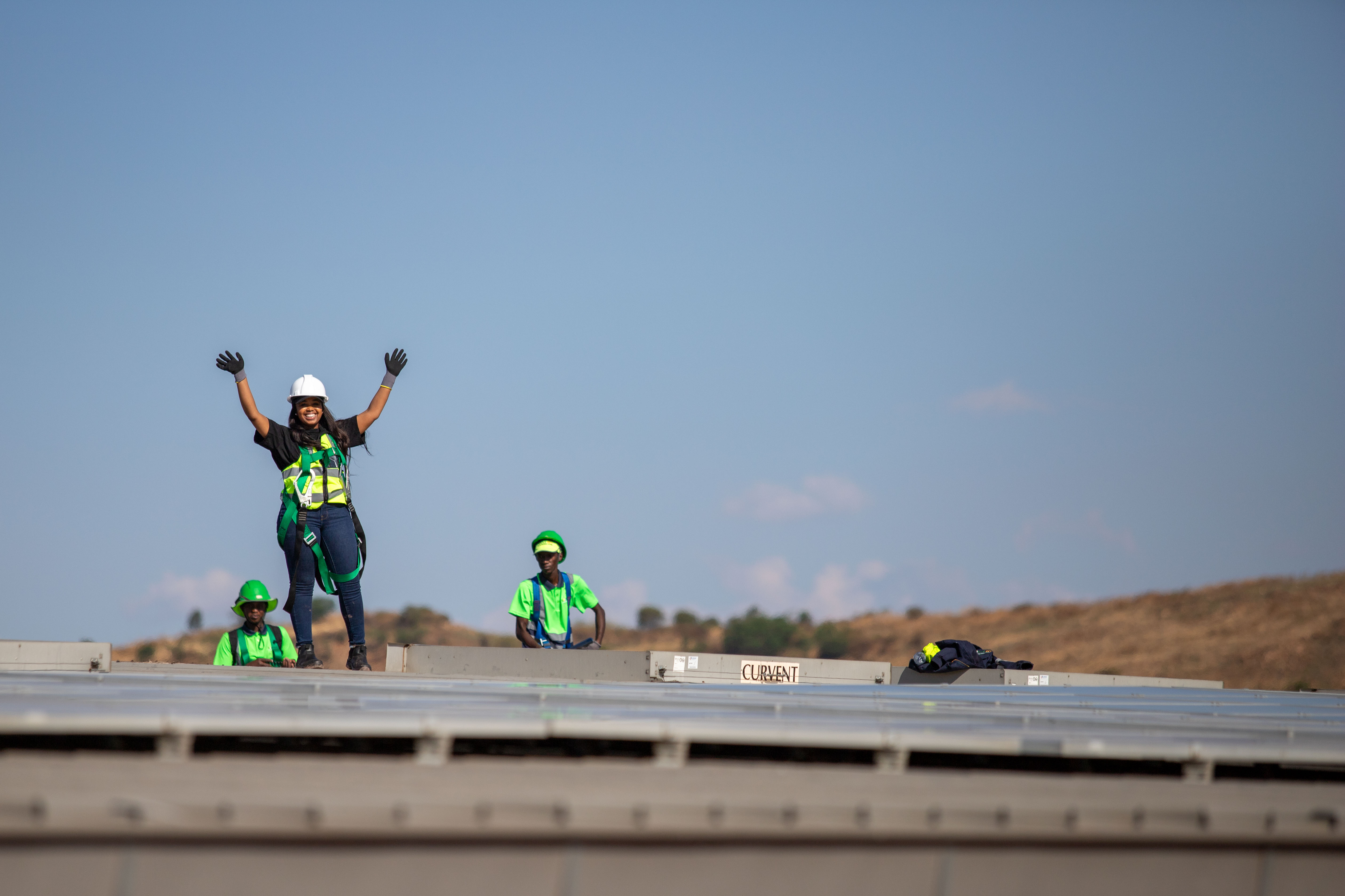 Crew cleaning solar panels using soft water brushes